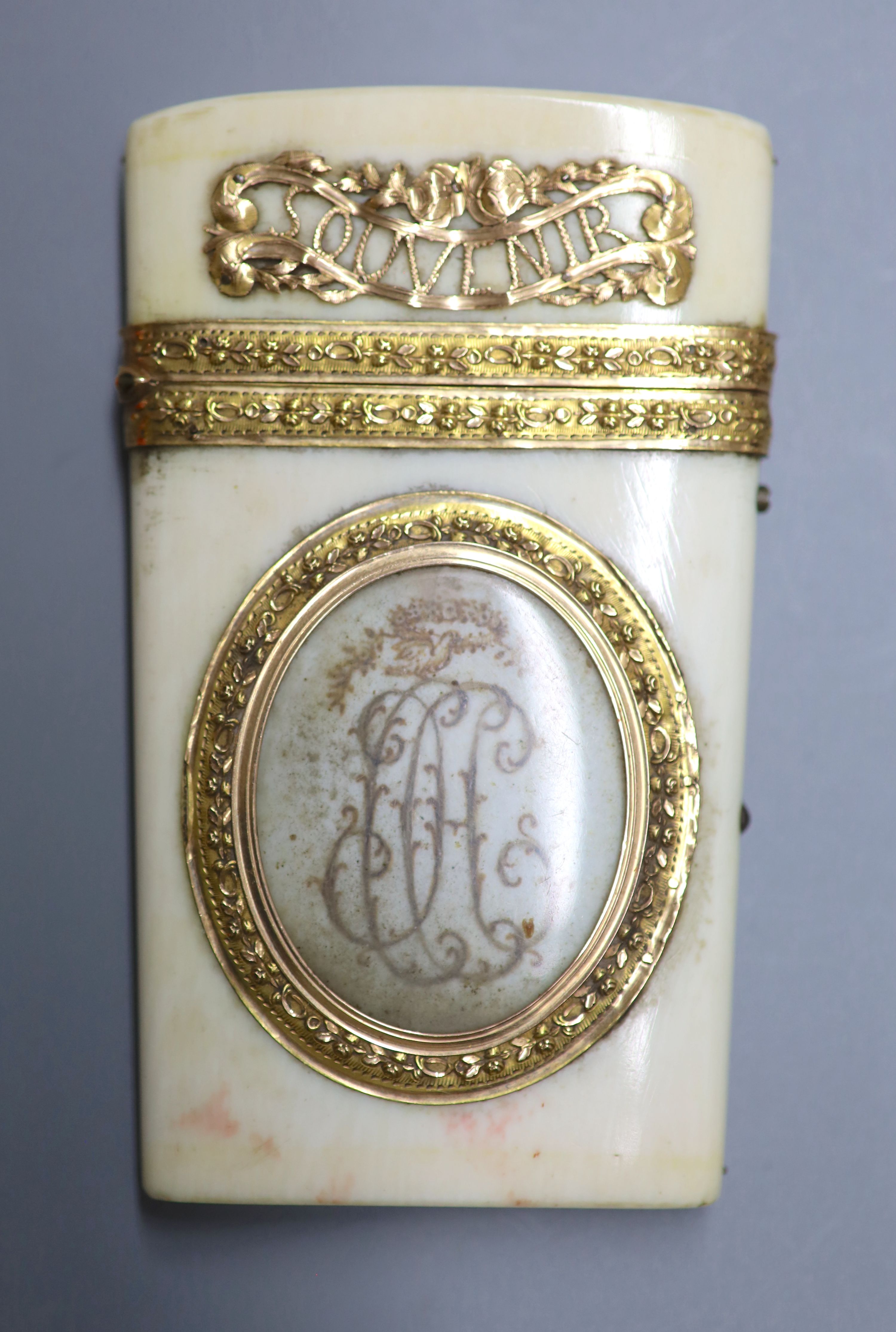 A 19th century French yellow metal mounted ivory etui, inscribed Amitie & Souvenir with two fold notelet inside, 9CM